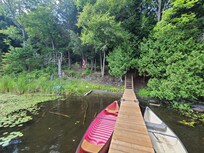 On the dock facing the cabin