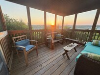 Screened porch with beach roses right outside.