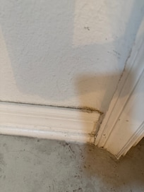 Dirty baseboards and flooring.