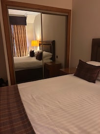 Wardrobe storage with robes, slippers and a safe