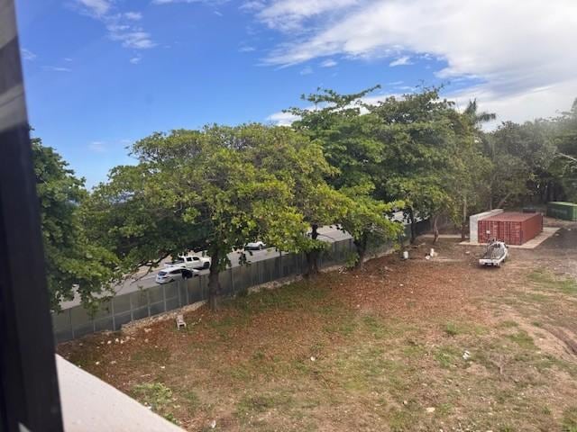 View from the back bedrooms to the empty dirty lot which is behind the building and trucks line up all night long to party until 1:00 AM then sleep with the trucks running all night. 