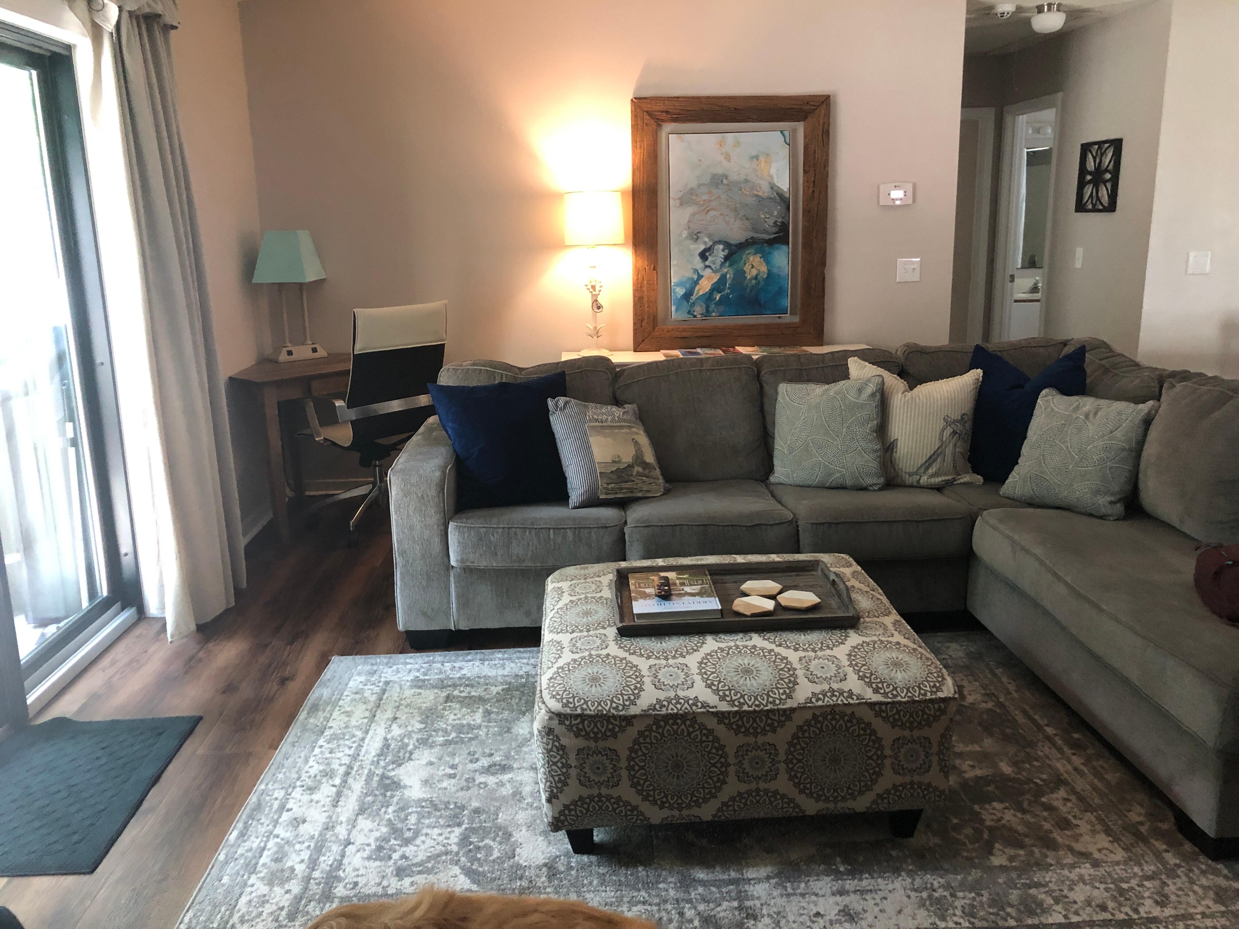 comfortable living room w/ desk ( all 4 sliding glass doors lead into fenced in backyard. 