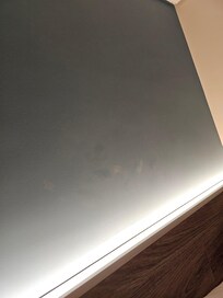 White crusty marks and foot/hand prints above the bed. They were behind both beds.
