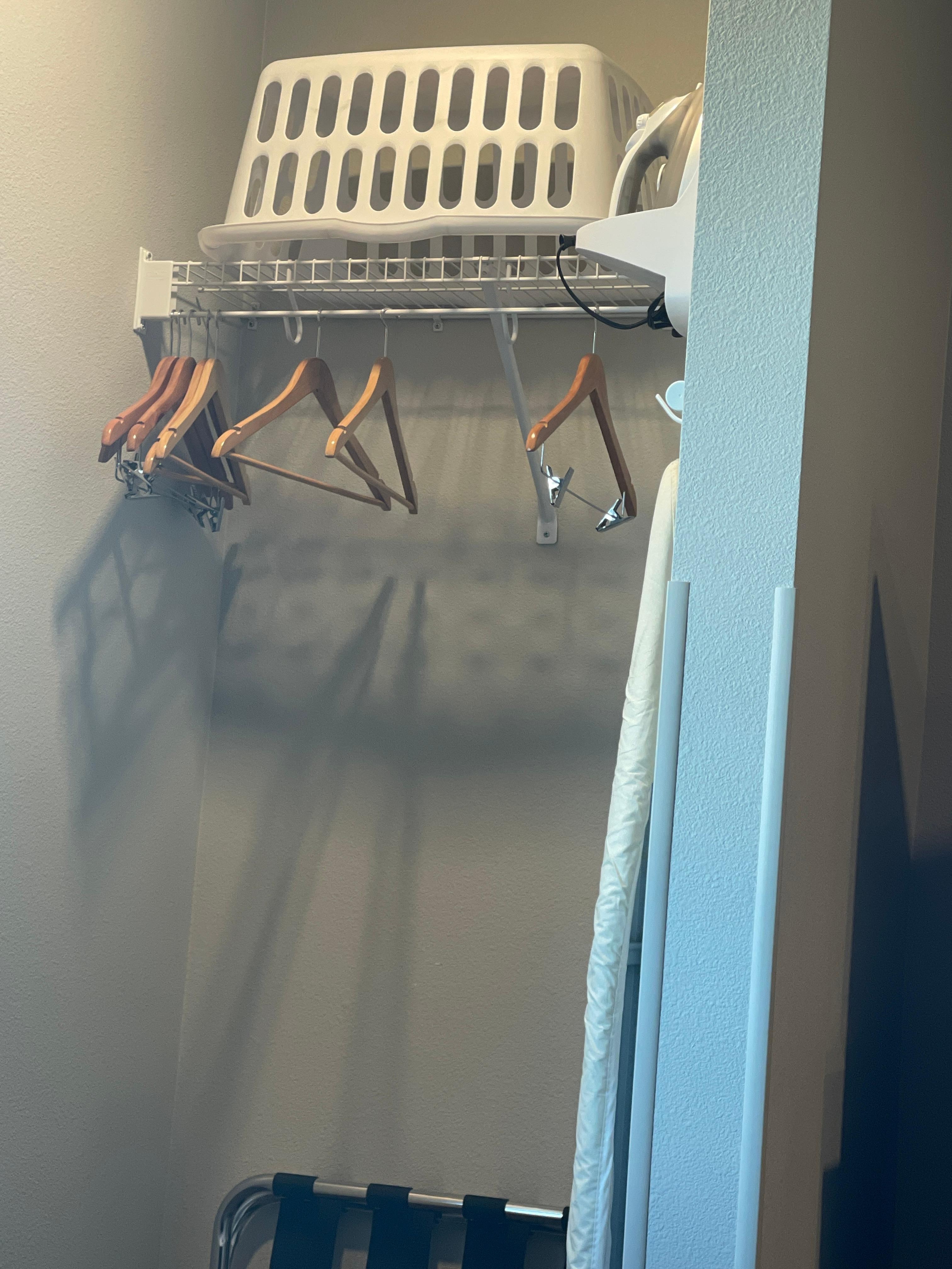 A laundry basket, iron and board.