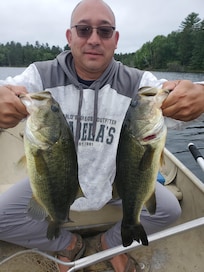 Papa and grandma caught each bass same time on row boat
