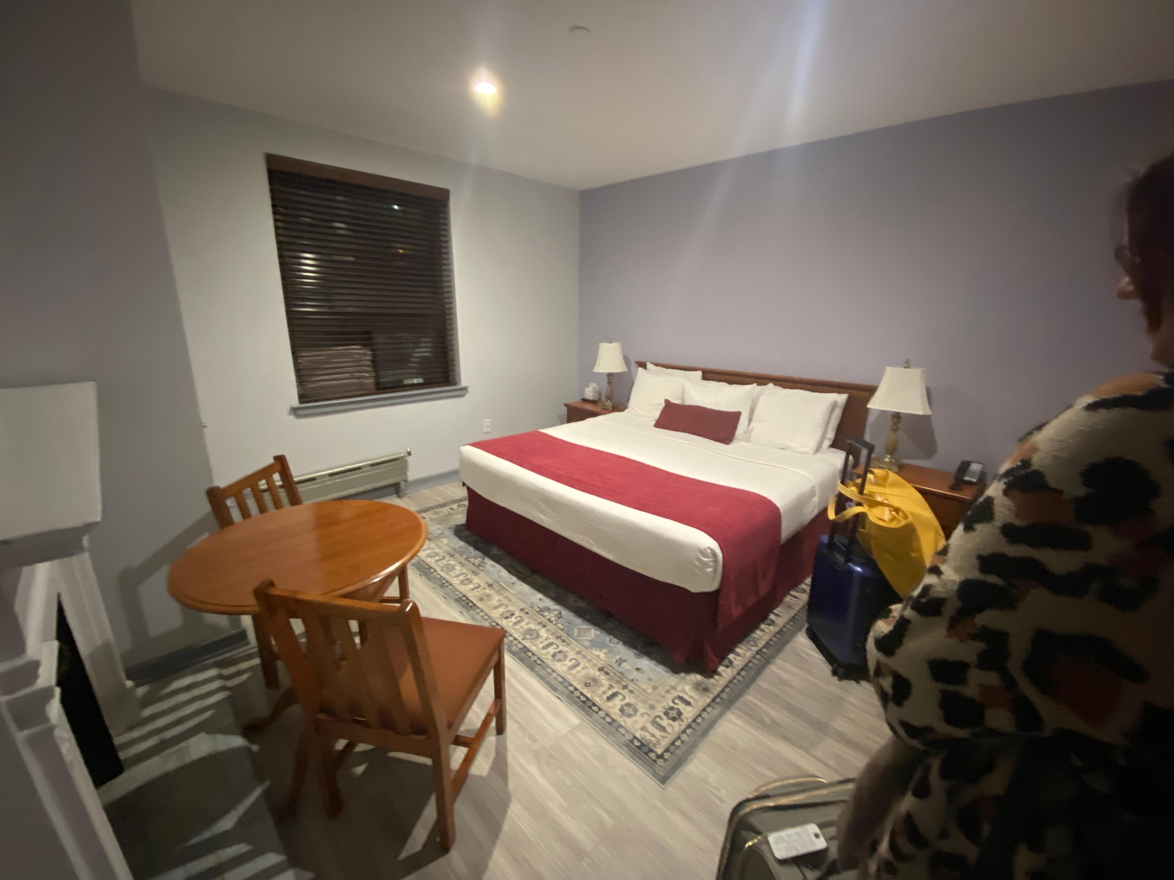 Room with king size bed and fireplace. 