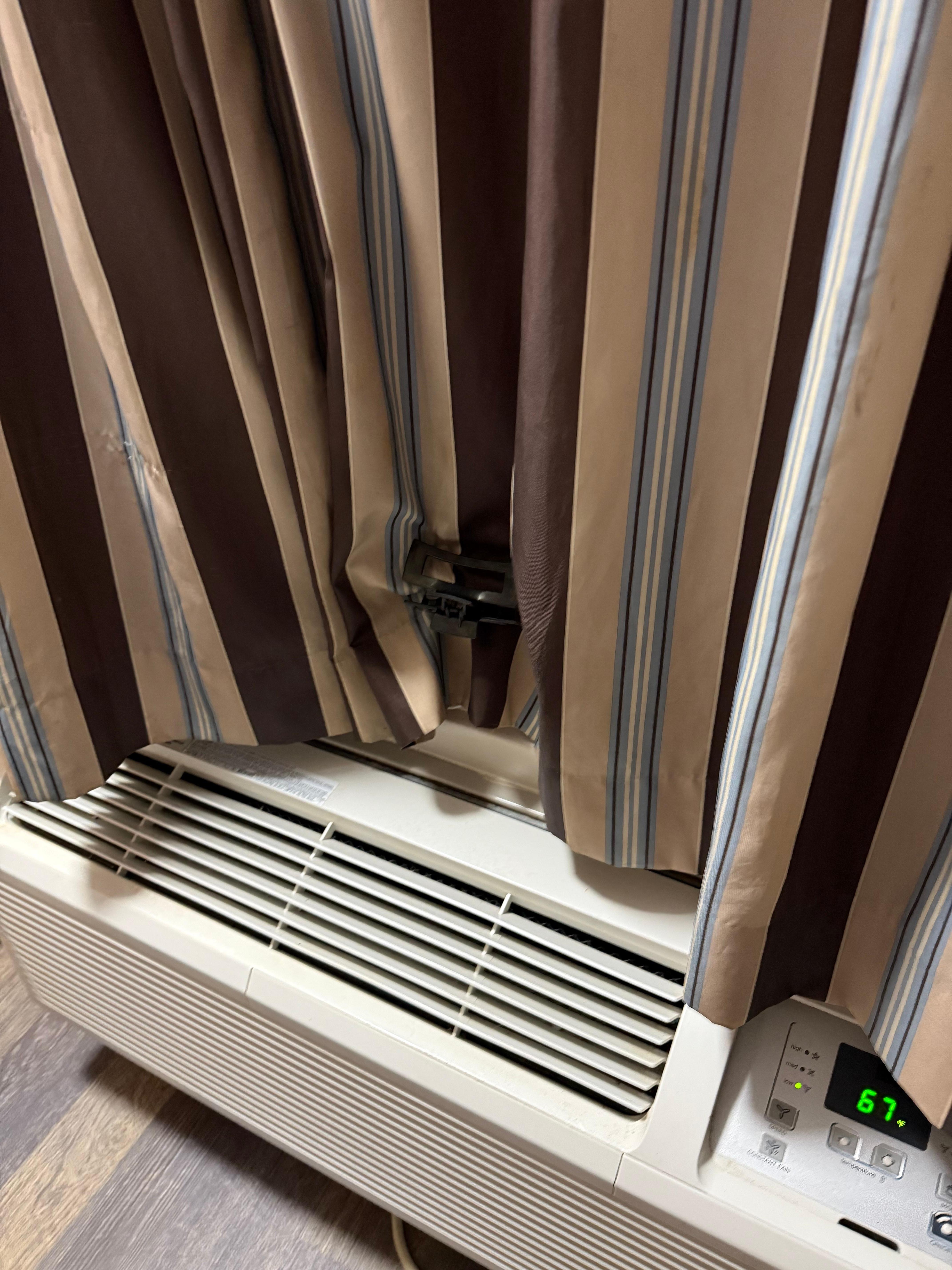 We needed to use hair clips to keep the AC unit from opening the curtains.