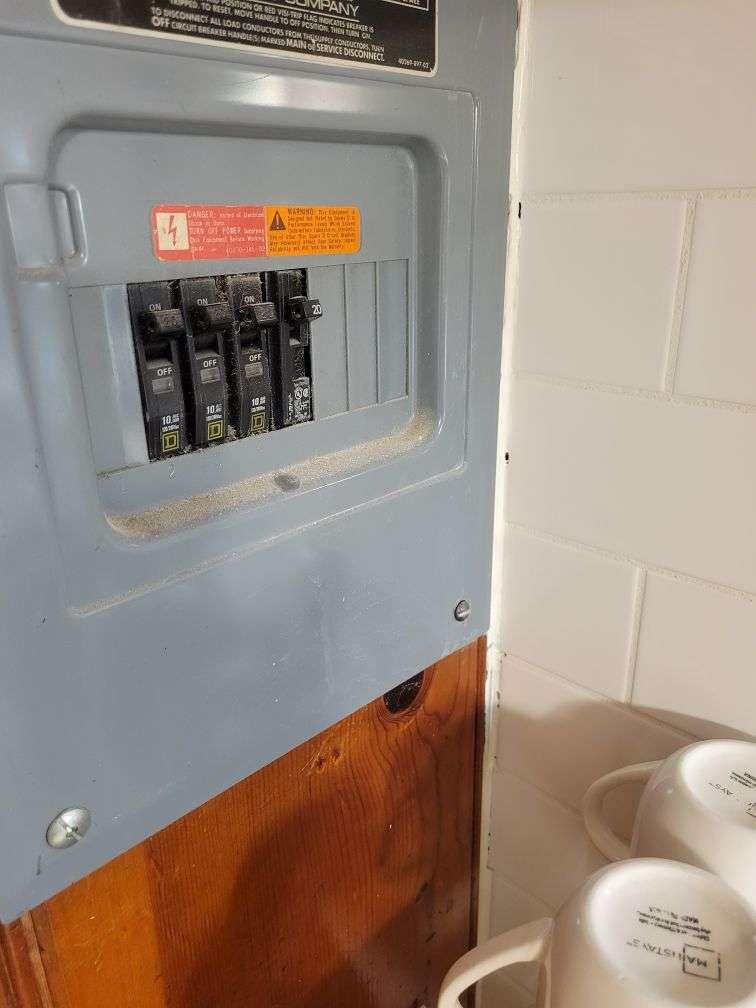 Dirty breaker box above drinking cups