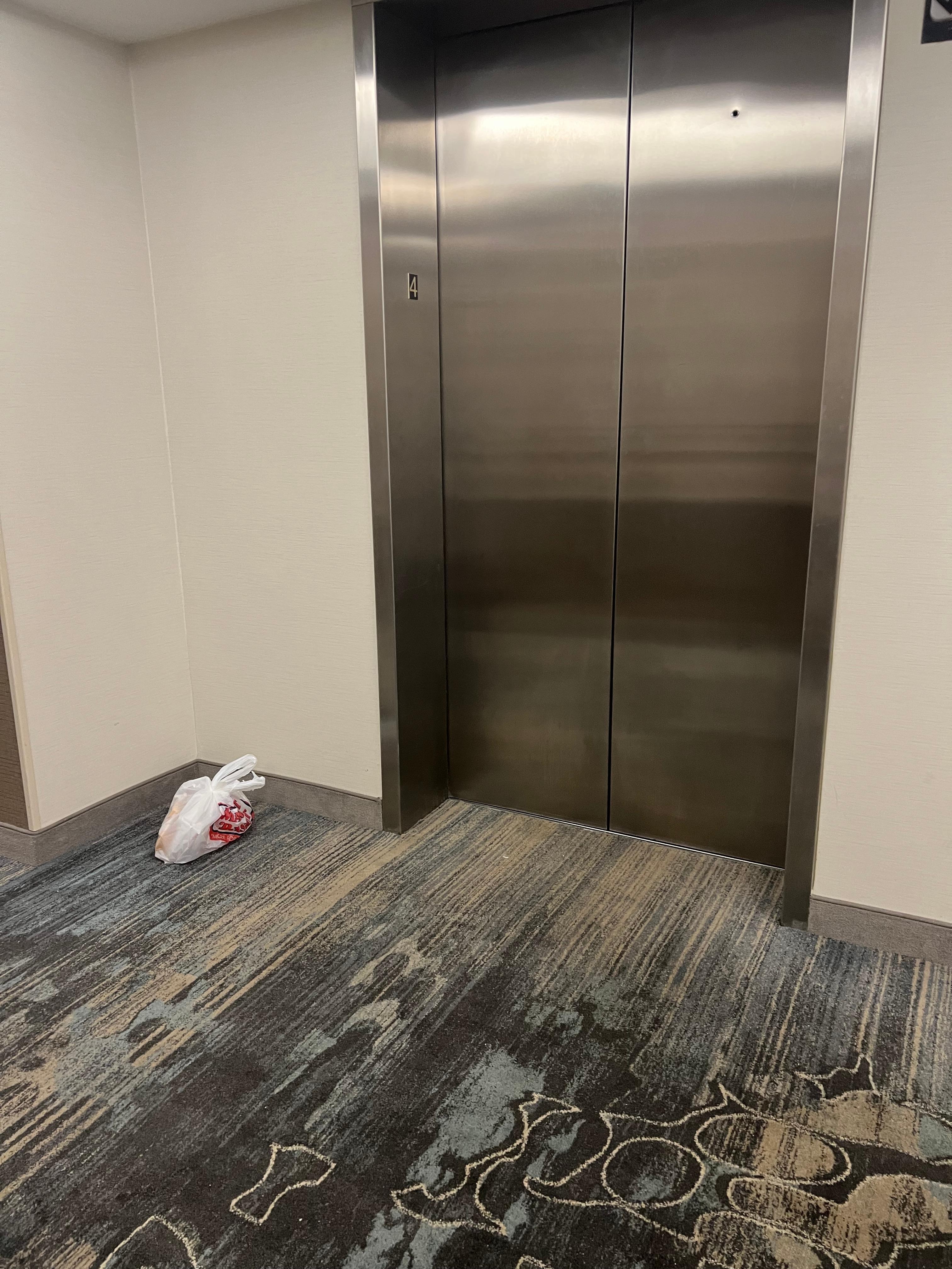 Garbage left next to elevator overnight. 