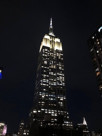 View from the hotel terrace on the rooftop by night: the Empire State Building