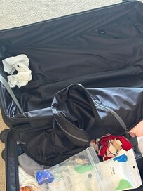 The whole suitcase of clothes was soaked in water.
