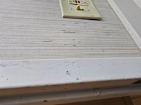 Gross junk on bathroom wall.