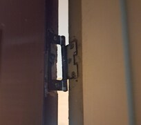 Entry door hanging off its hinge