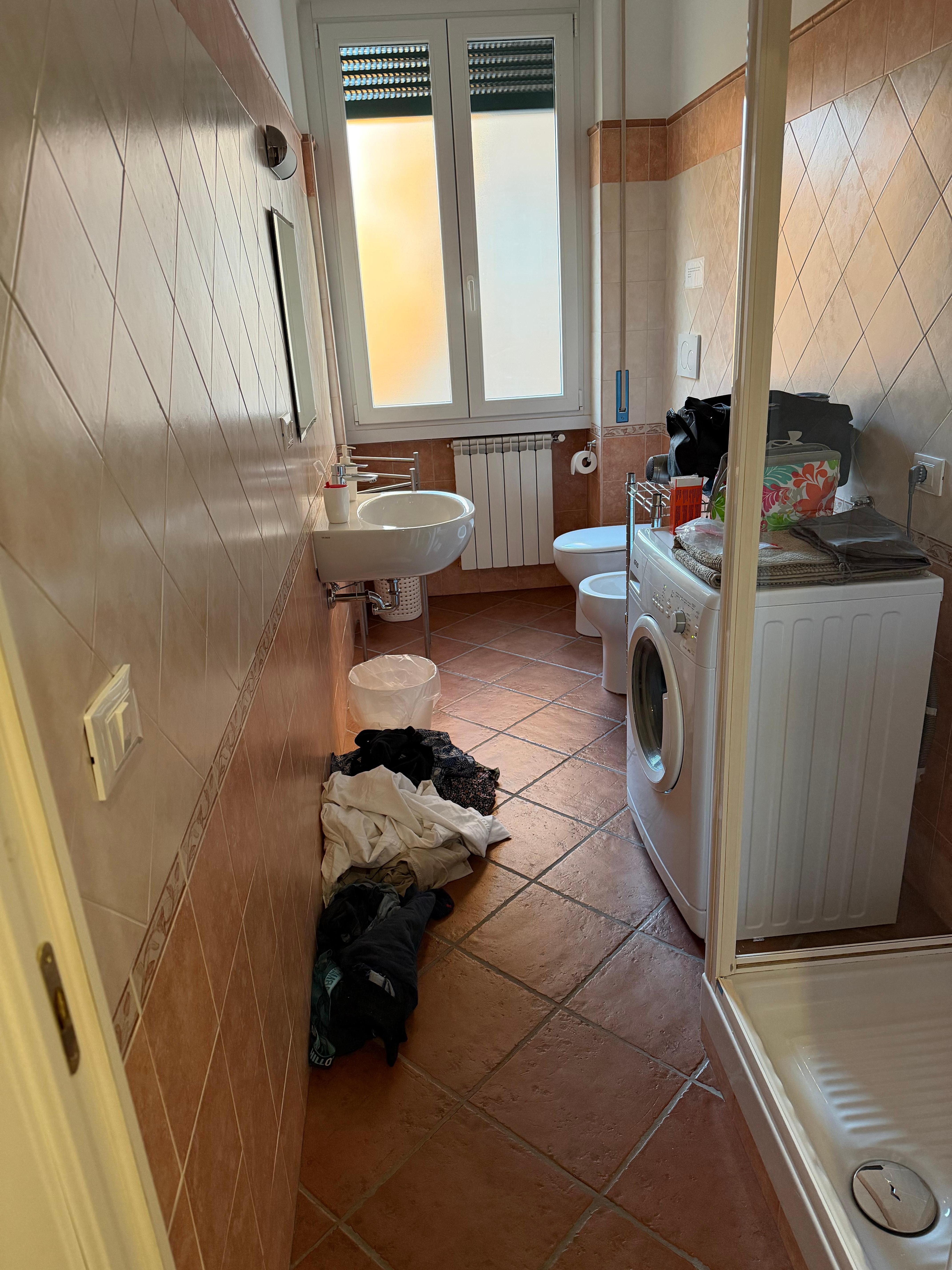 Bathroom with small washer. (Excuse our stuff)