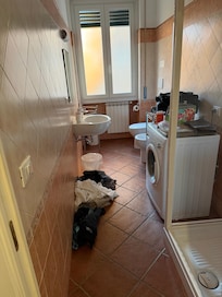 Bathroom with small washer. (Excuse our stuff)