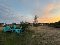 Fire pit and back of cottage in the distance