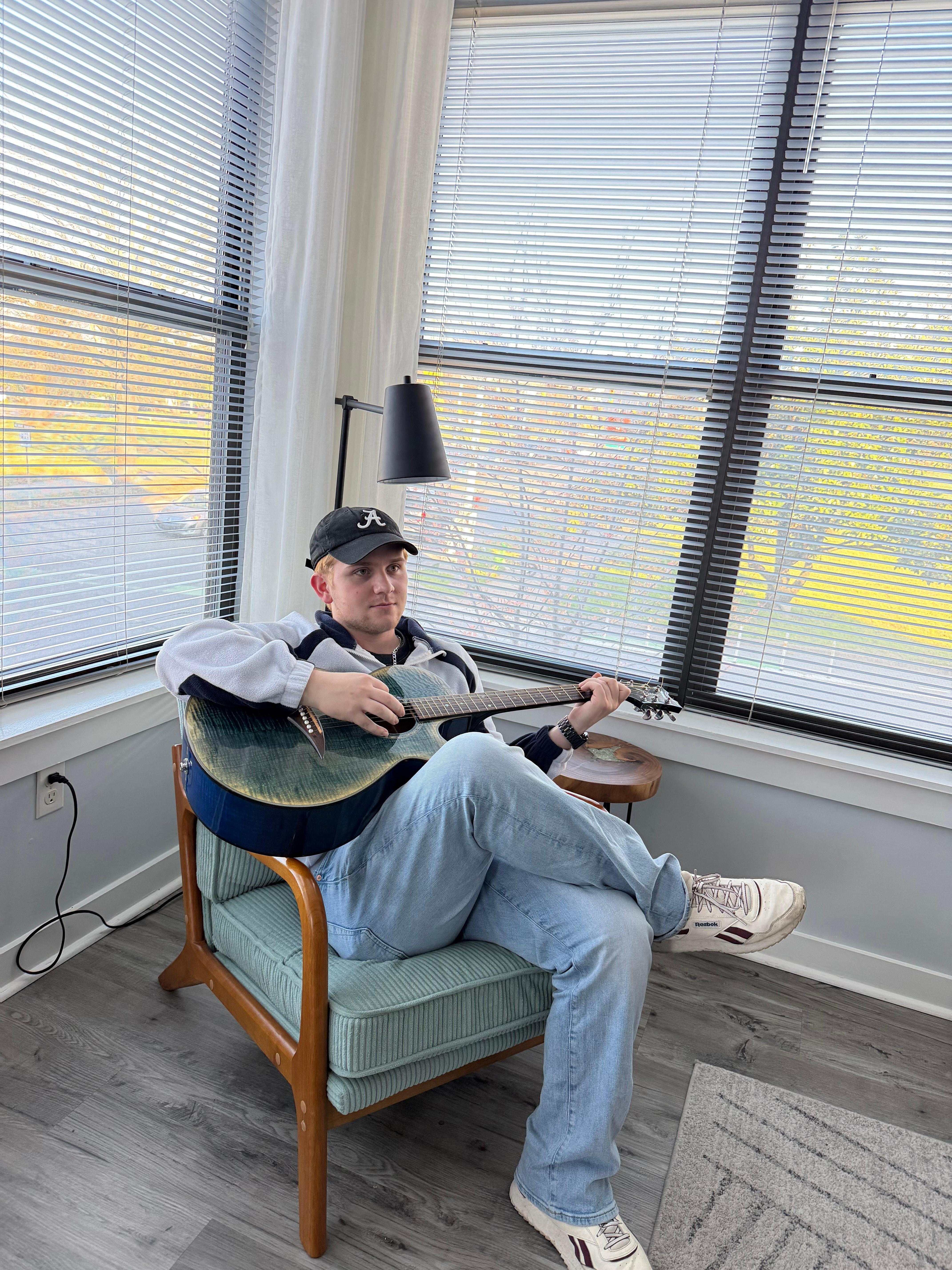 Aiden Flowers of The Warmup Room enjoying the guitar and picks provided. Most excellent!