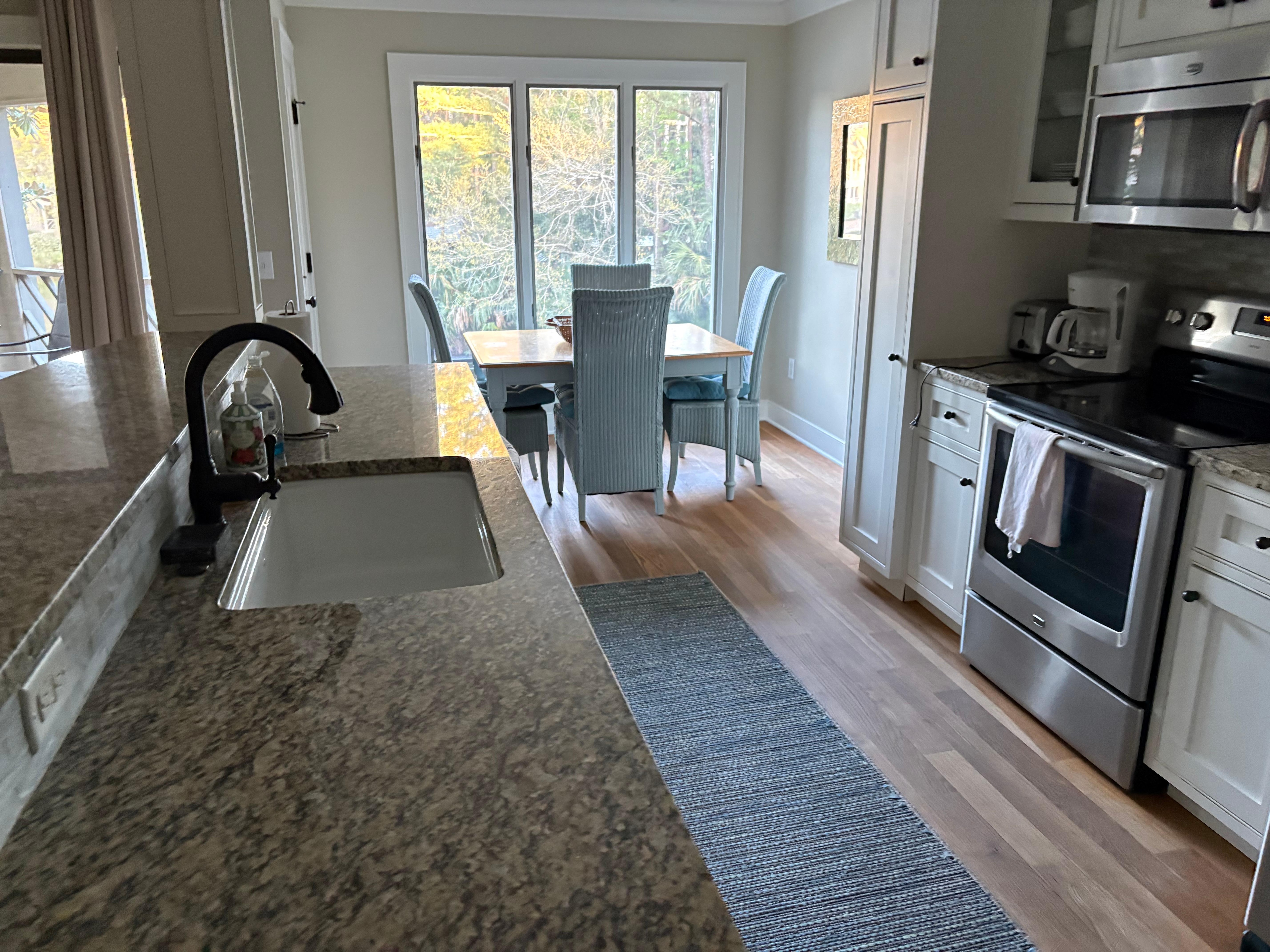 Big kitchen with toaster, coffee pot, keurig, seasonings, fridge, oven, dishwasher.