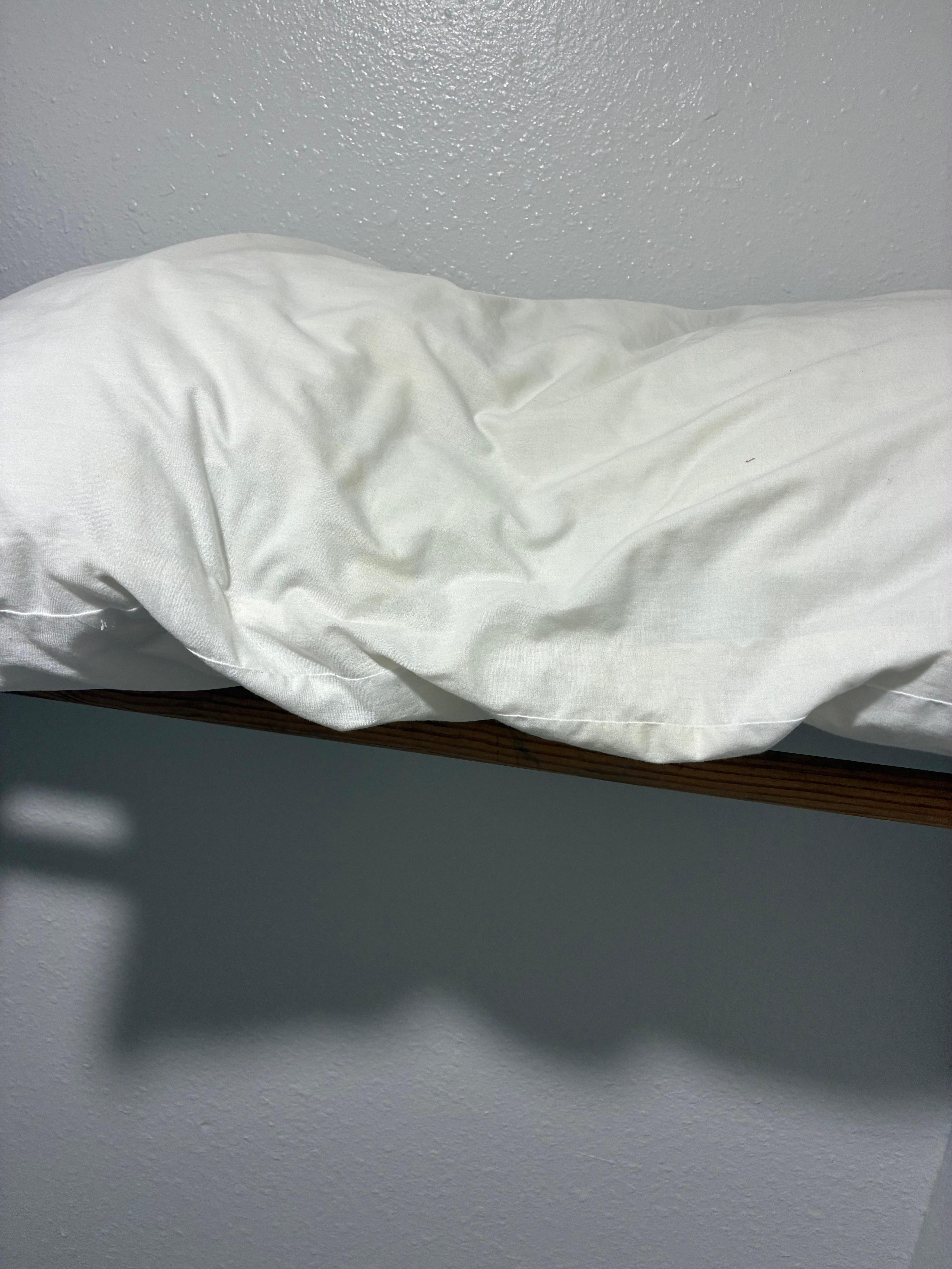 extra pillow in closet yellow and dingy