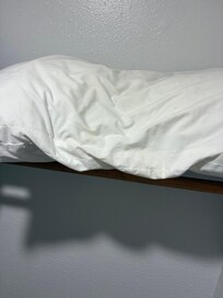 extra pillow in closet yellow and dingy