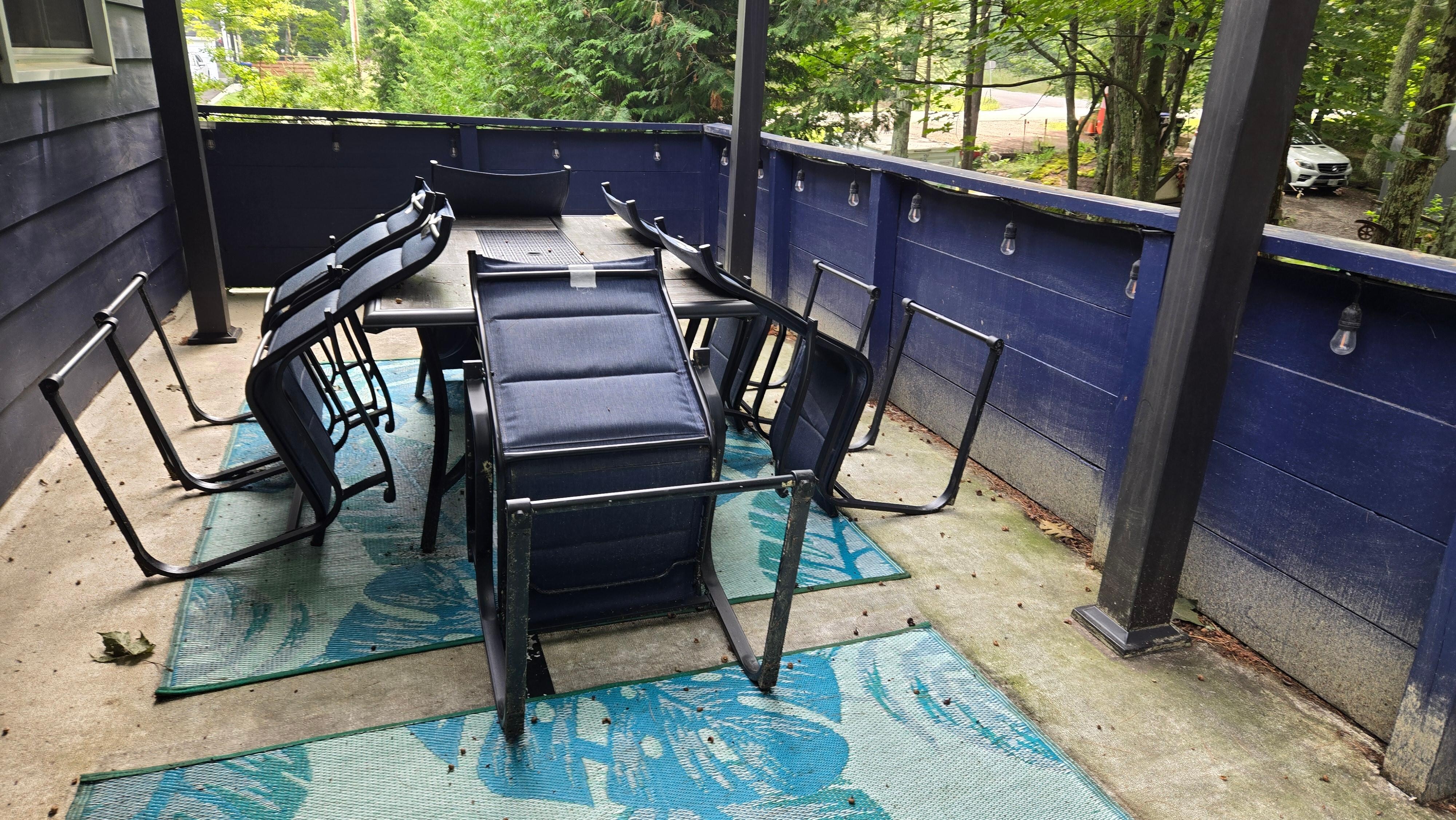 La table à l'extérieur, derrière.  Tout est sale, et endommagé.  Pas de toit au dessus pour couvrir en cas de pluie.