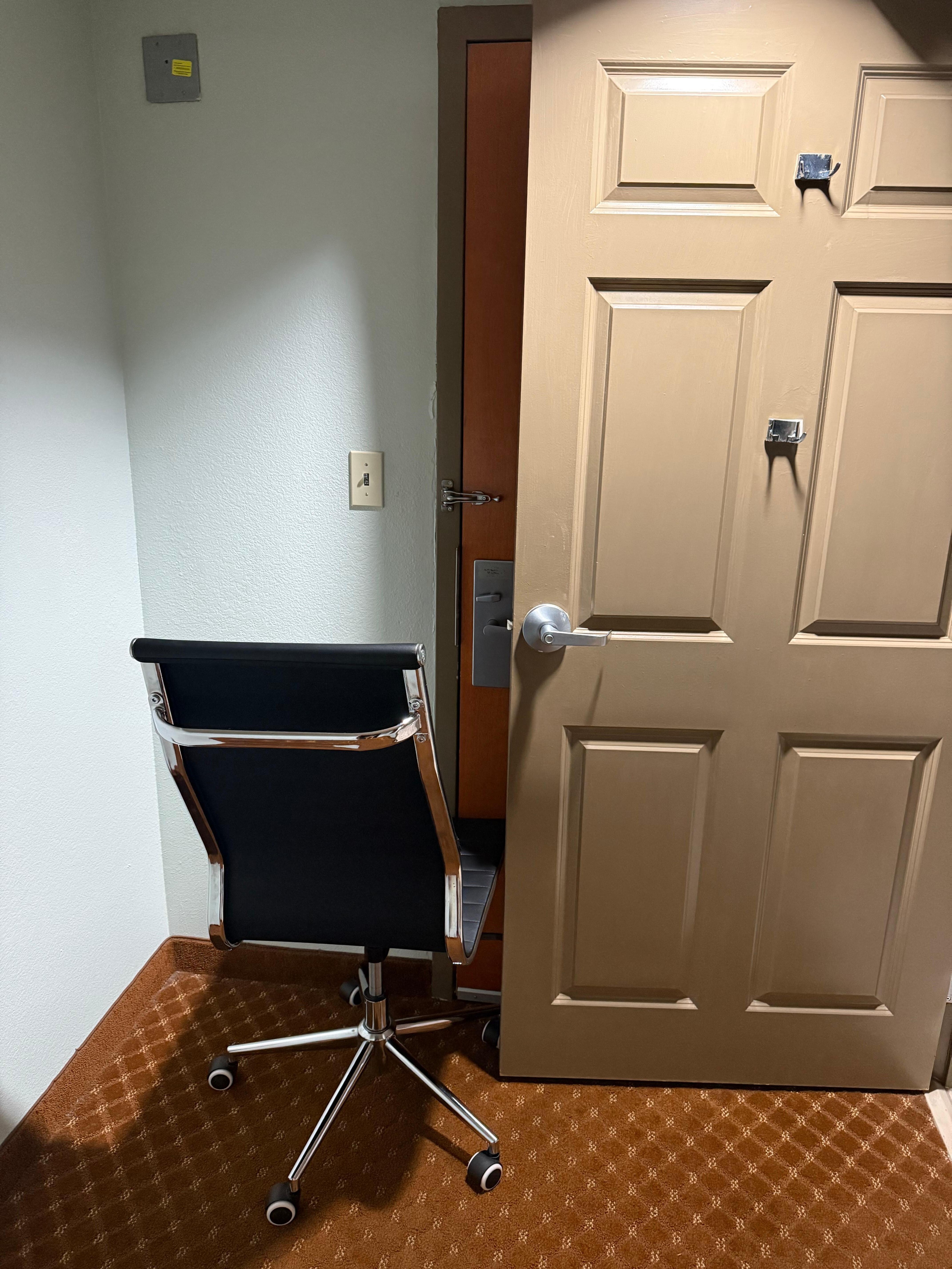 Deadbolt is on. Chair is there. Door of the bathroom is there, and this is for me to hear if someone tried to get in. 