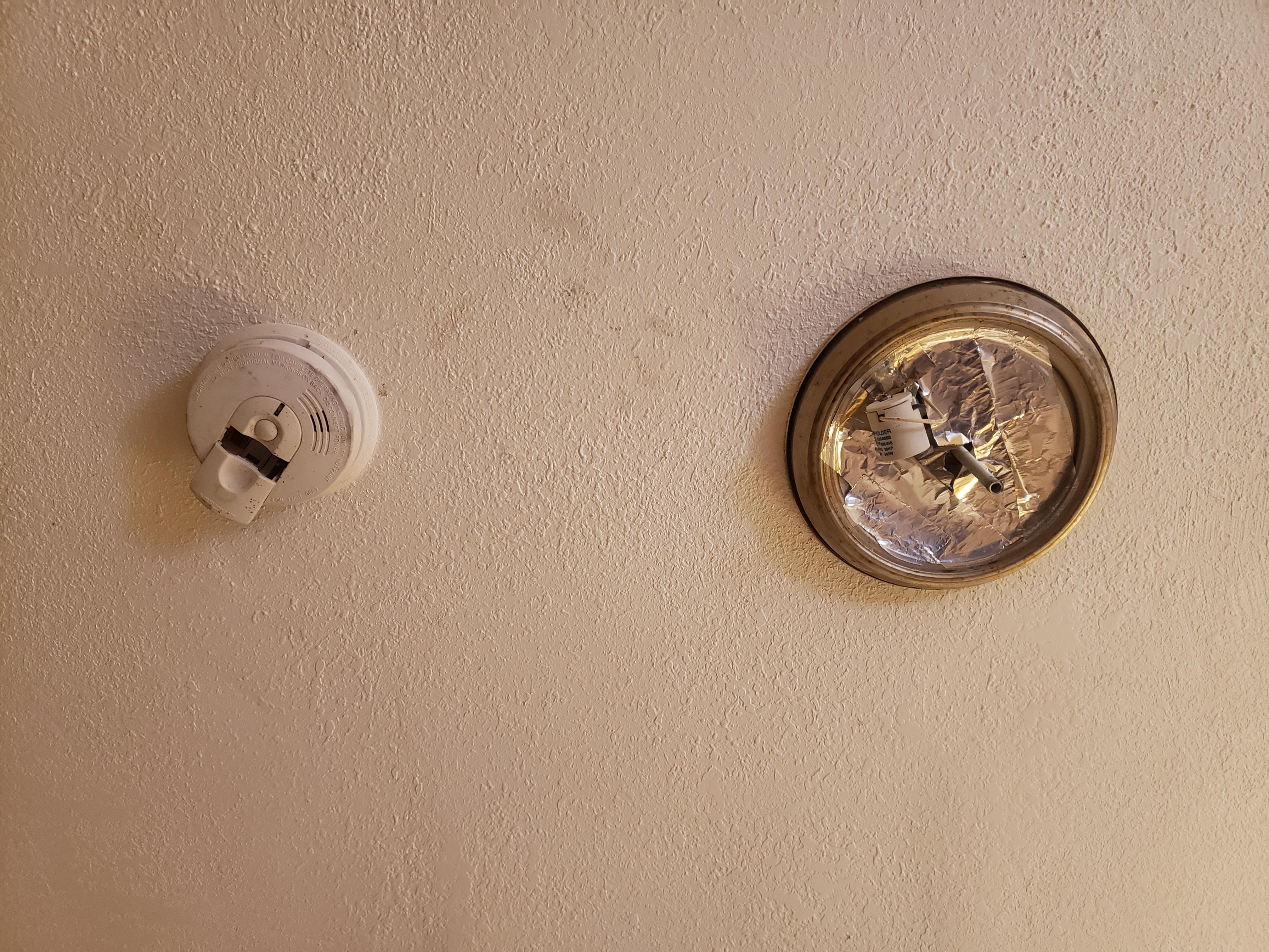 Smoke alarm no batteries, ceiling light damage.