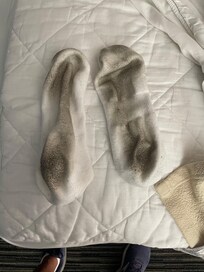 Photo of the bottom of socks after about 2 hours in the room, they were new when I put them on.