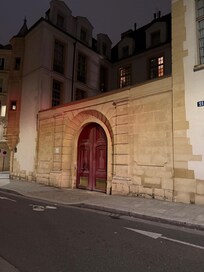 The entrance to the courtyard of the building at night. The door to the apartment is just inside the courtyard.