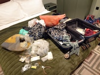 The suitcase had its lock broken, was opened, ransacked, and had water poured over it.-1