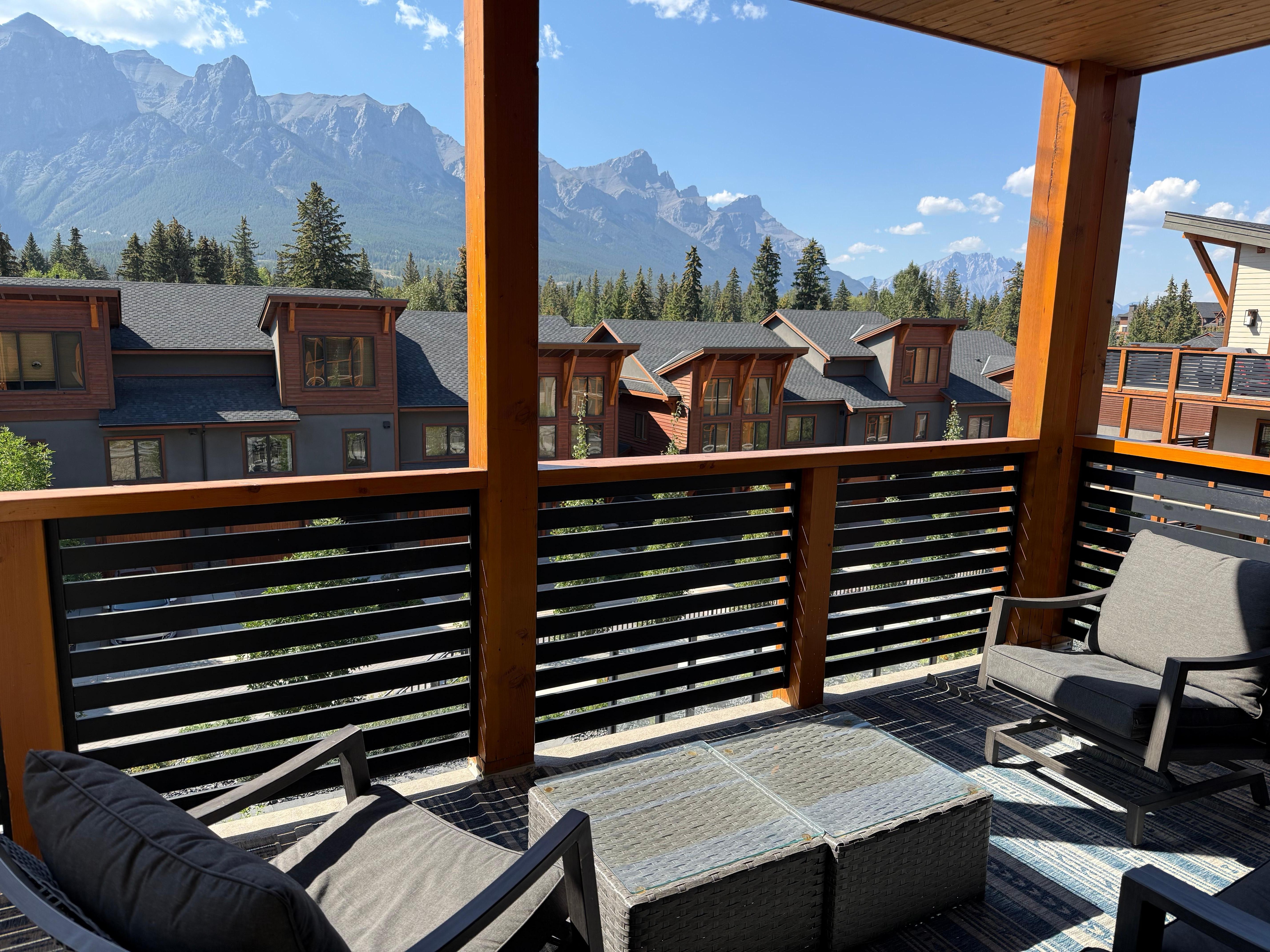 Balcony with comfortable furniture and great view of mountains