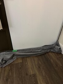 Blankets on the floor to attempt to keep cold out of room.