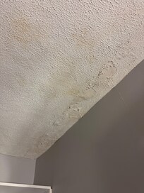Water damage where spackle falls off onto the dresser. This place looks NOTHING like the pictures! The floor is also VERY un level.