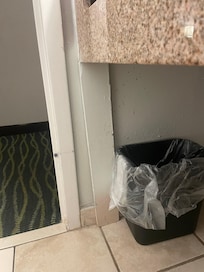 Board bracing up the bathroom counter