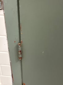 Chipped and rusted doors in bathroom