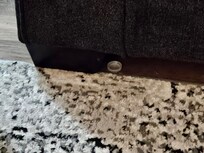 trash visible near the edge of the couch