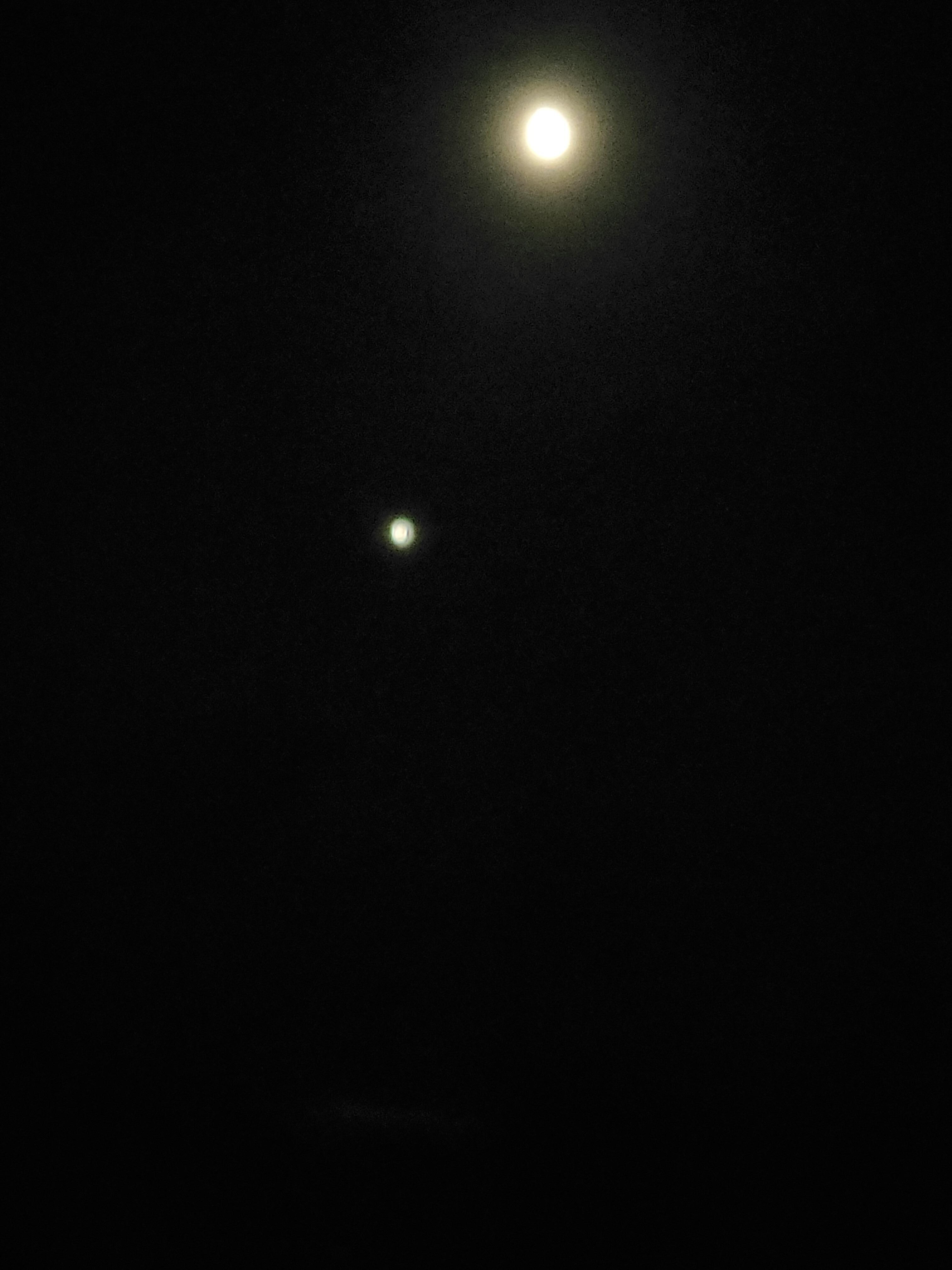 The moon and Venus over the beautiful ocean view.