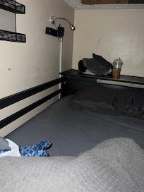 You can see they didn’t remove the sheets and left the used bedding, towels and a drink - I had to remove them before putting on the blue sheets seen in the bottom left corner. Mattress was stained too and you can see smears of something on the wall