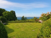Blick auf die Förde und den Garten vor dem Haus