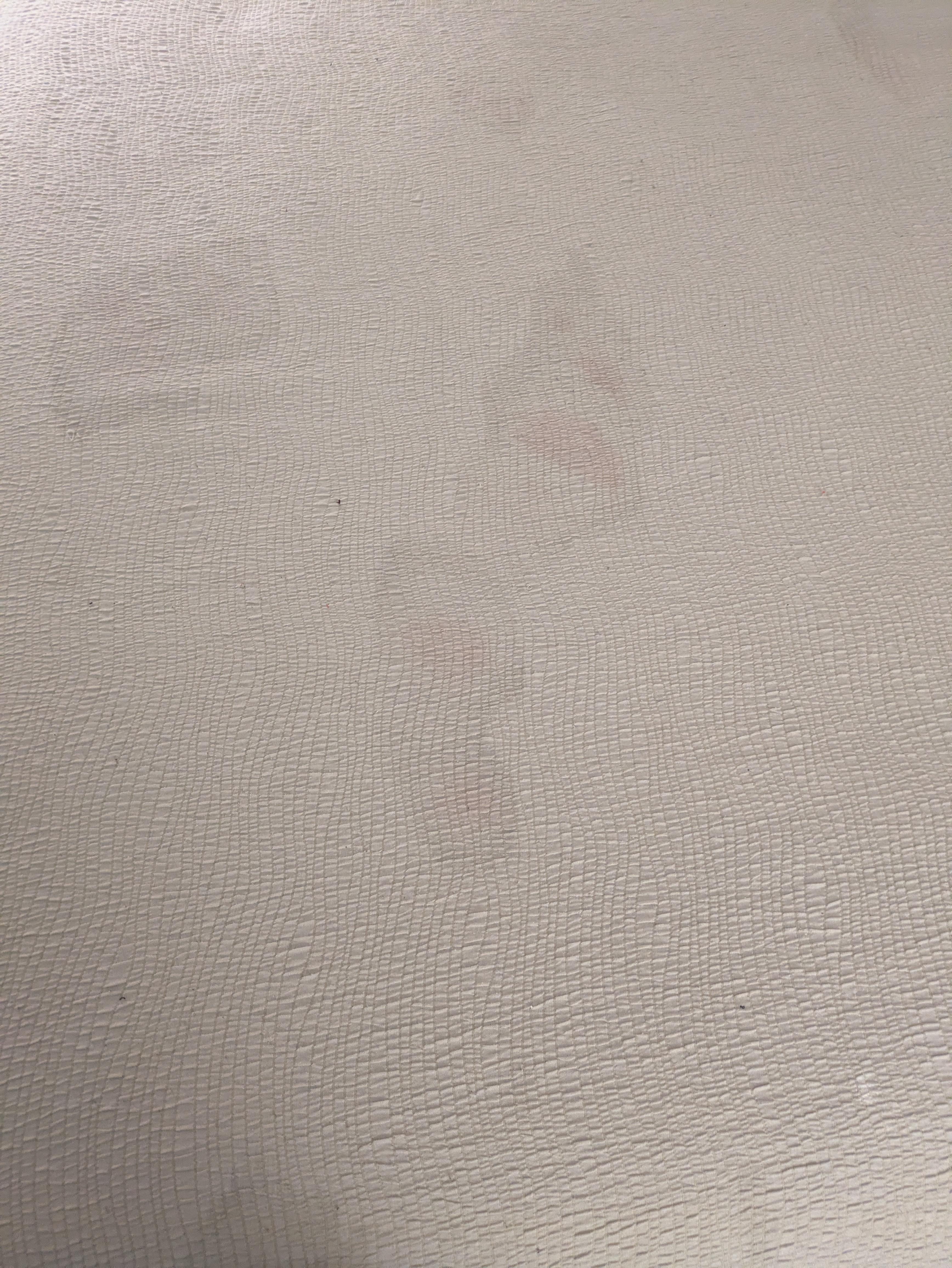 Children's footprints on bedding.