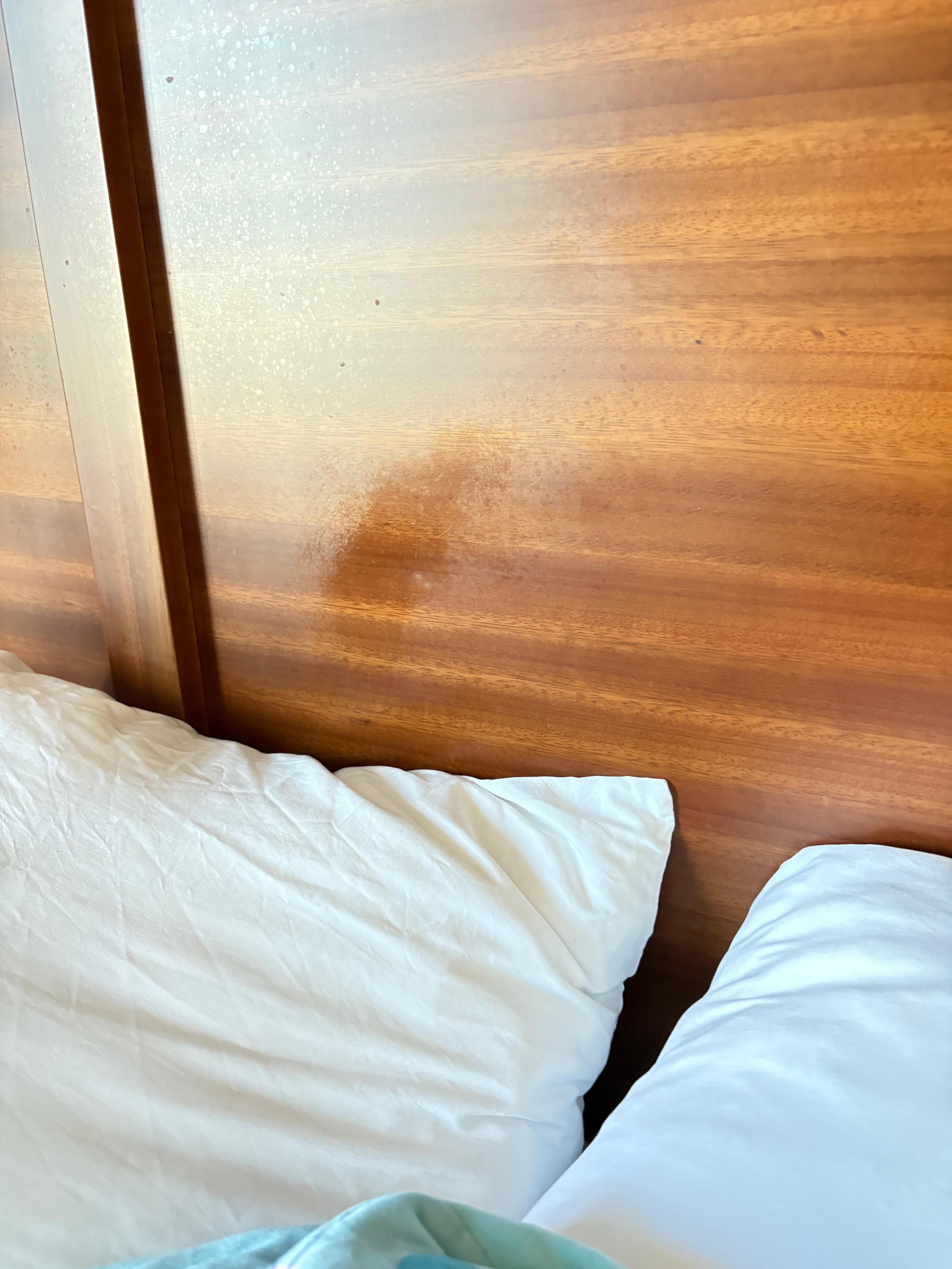 Stain from a greasy head on the headboard 