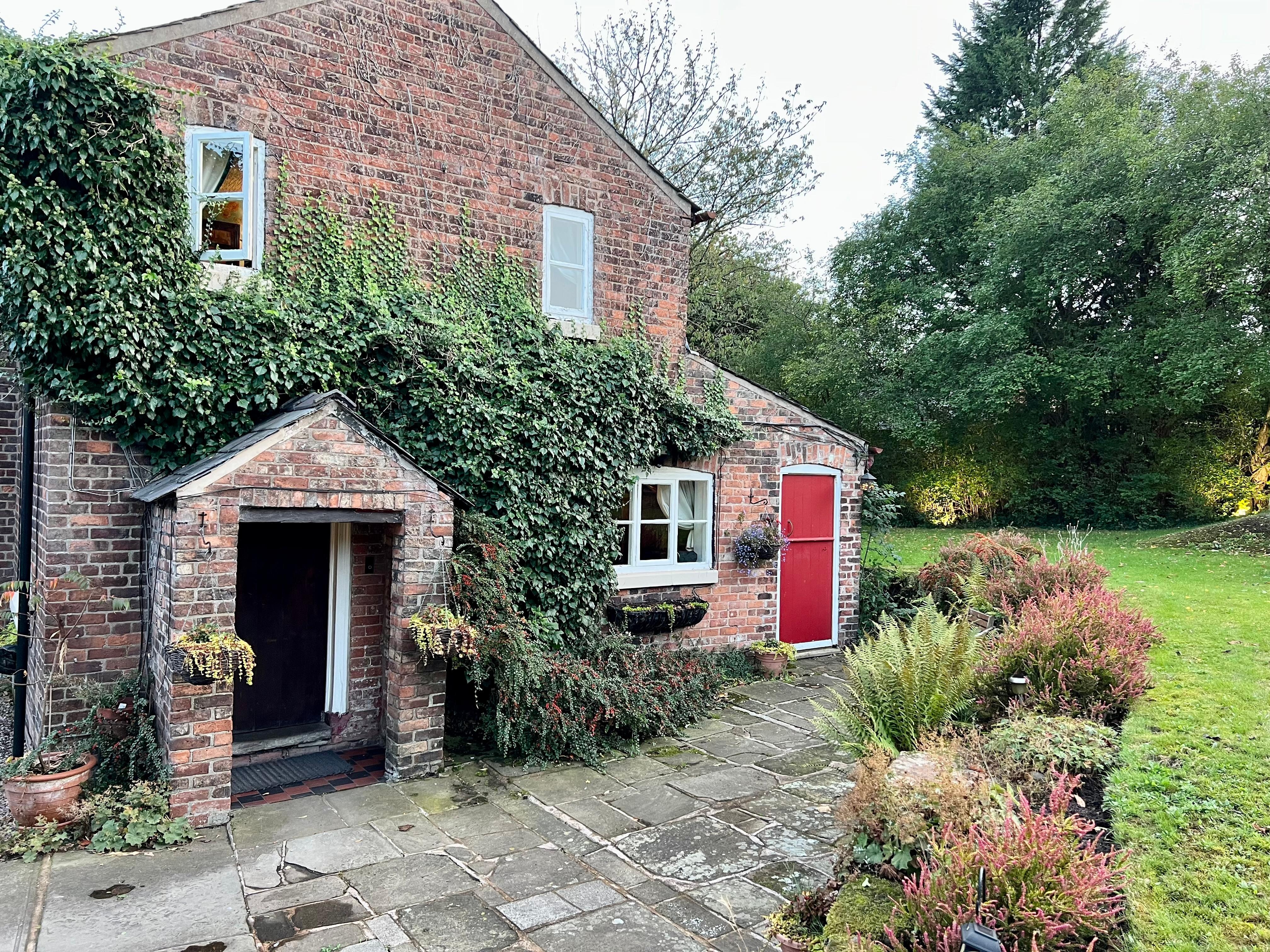 House rear with guest entrance (in porch) and the small double room (red door).