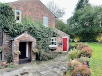House rear with guest entrance (in porch) and the small double room (red door).