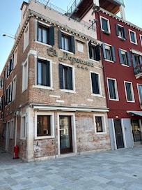 Front view and the entrance is on the side. The front is a store/bar that has tables out front.