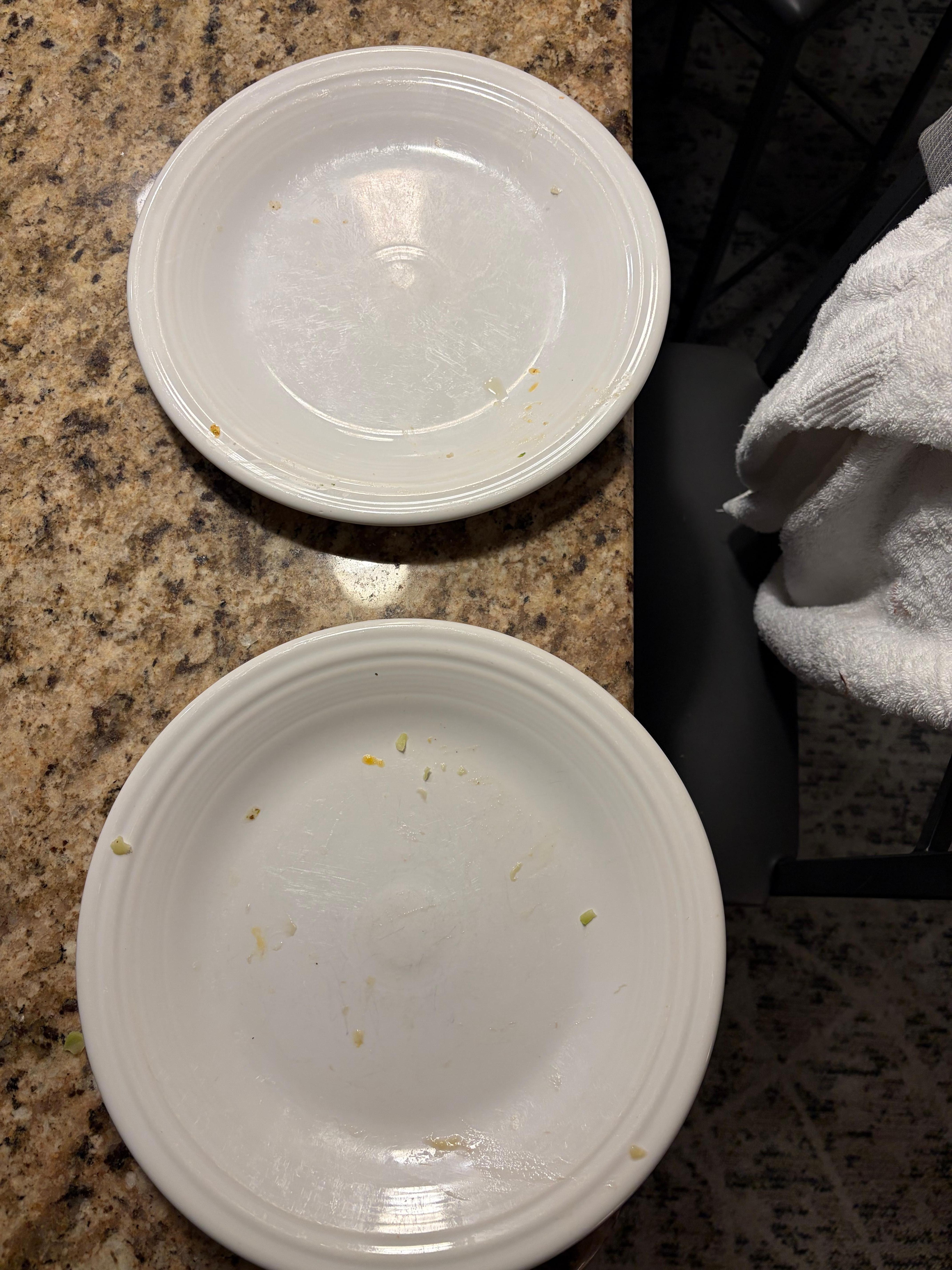 Dinner plates covered in dried on food . Forks were dirty also . 