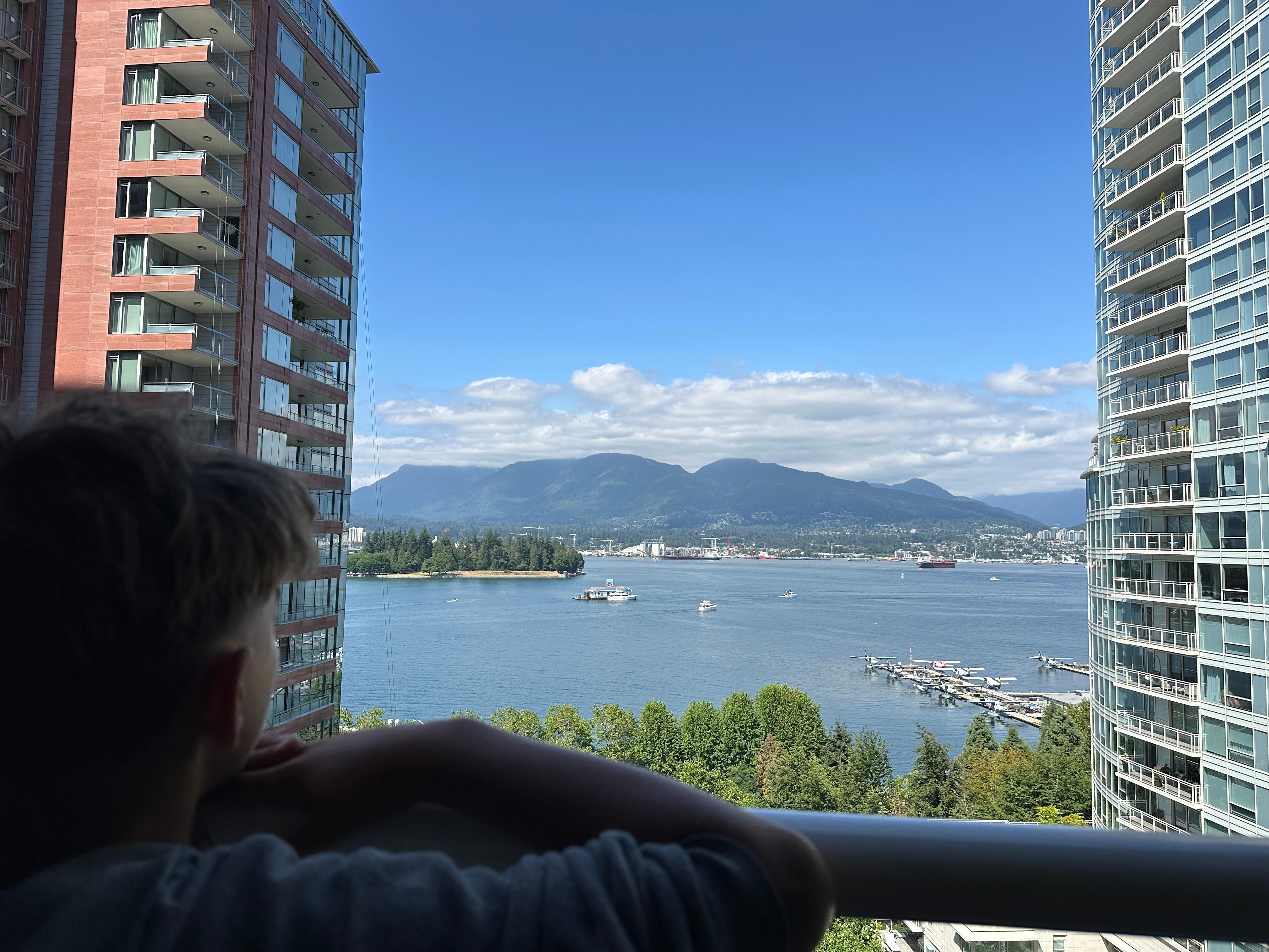 Grandson admiring the view of Coal Harbor from our Pinnacle Hotel Harbourfront balcony