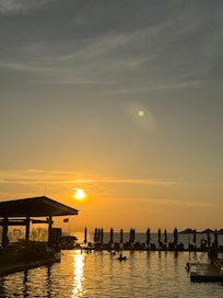 Beach pool and beach at sunset