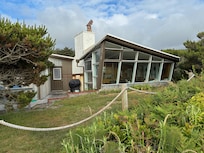 View of house from edge of bluff above beach