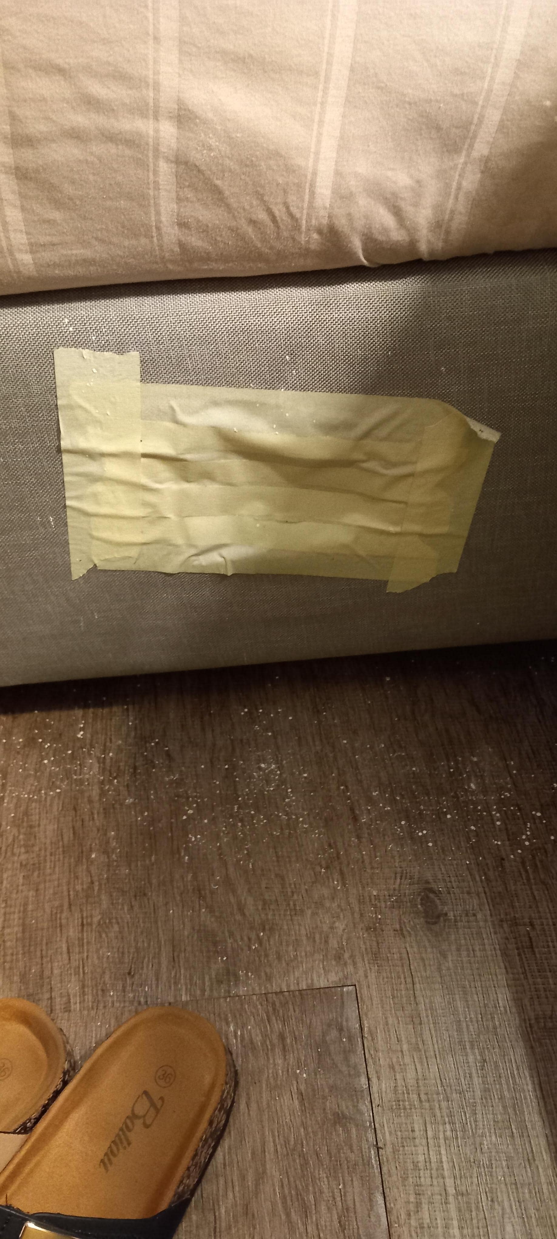 Taped up hole in the side of the bedframe