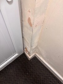 Plaster falling away at doorway to stairs